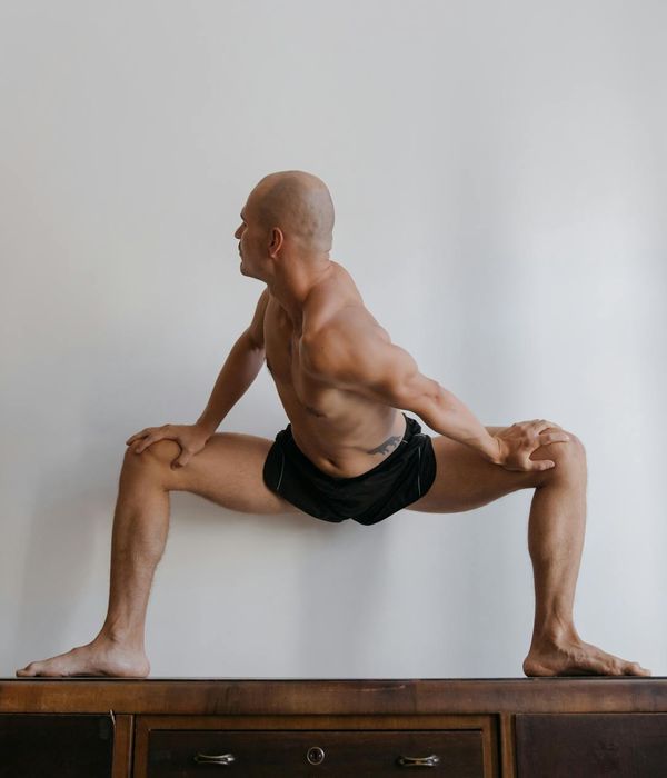 Athlete in a powerful yoga warrior pose, demonstrating strength and focus.